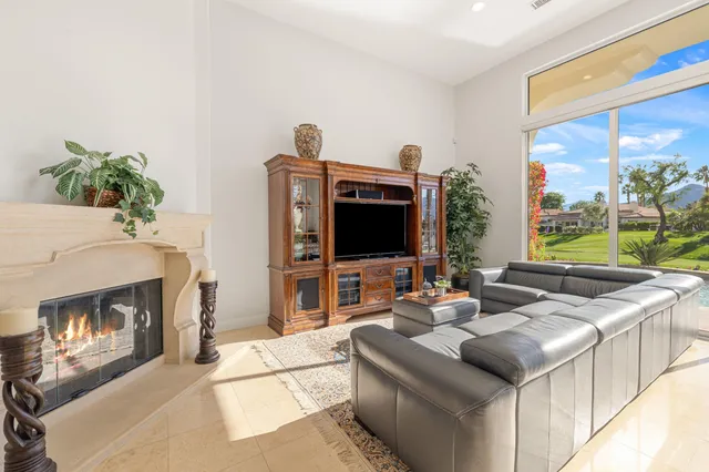 a living room with fireplace furniture and a flat screen tv