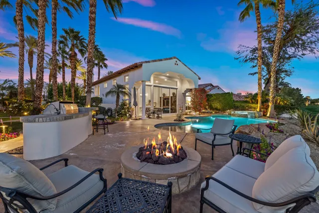 a view of a patio with couches and a table and chairs with garden view