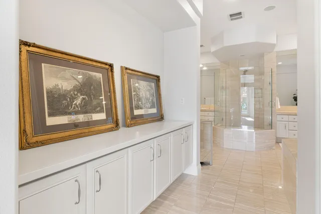 a spacious bathroom with a double vanity sink a mirror a bathtub and a shower