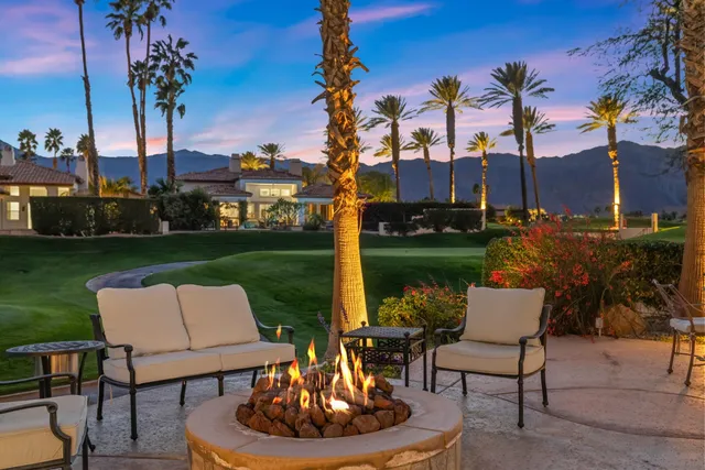 a view of a house with swimming pool and sitting area