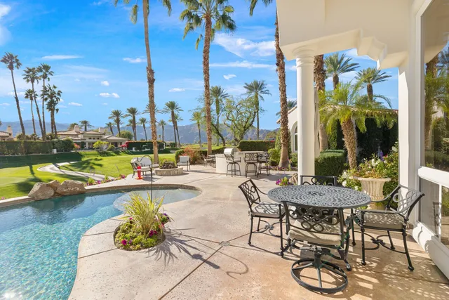 a view of swimming pool with outdoor seating