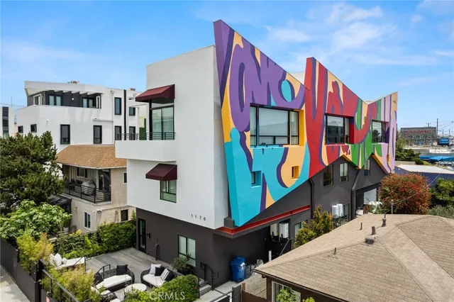 a living room with furniture a wooden floor and next to a window