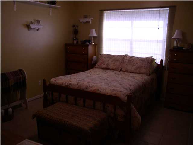 6172 Barnes Road Crestview, FL 32536 - Photo 4 of 8 a bed sitting in a bedroom next to a window
