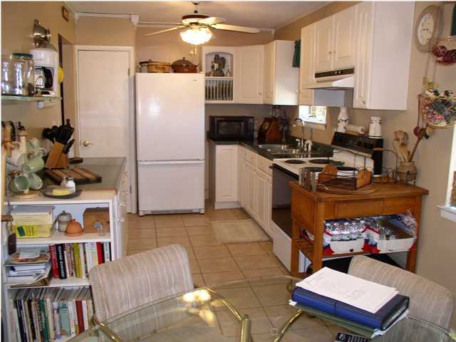 6172 Barnes Road Crestview, FL 32536 - Photo 8 of 8 a kitchen with a refrigerator and a stove top oven