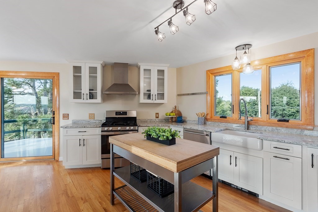 36 Osgood Road Sterling, MA 01564 - Photo 12 of 40 a kitchen with a stove a sink wooden floor and a window