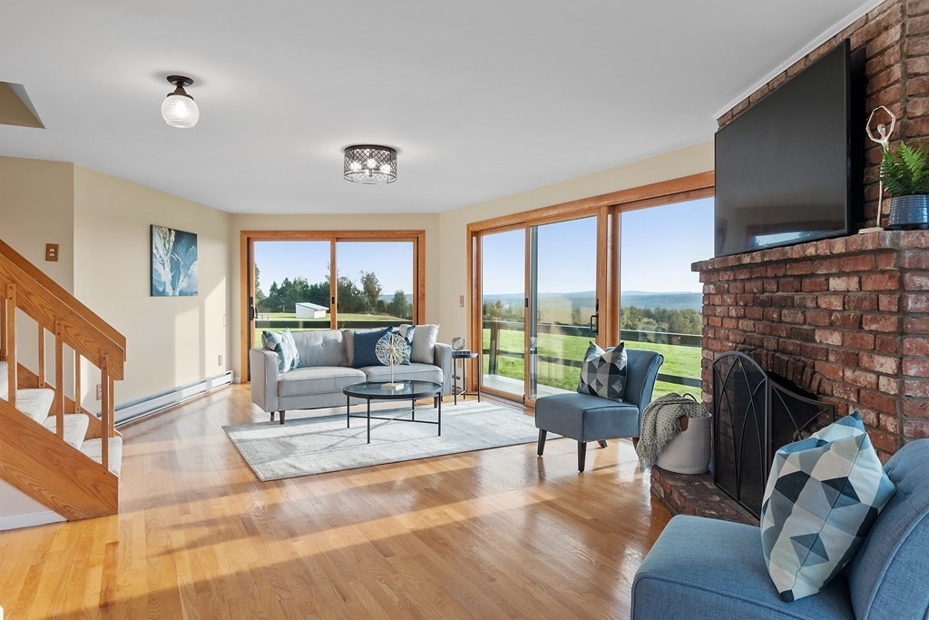 36 Osgood Road Sterling, MA 01564 - Photo 19 of 40 a living room with fireplace furniture and a flat screen tv