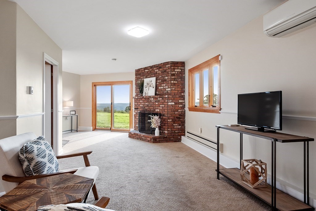 36 Osgood Road Sterling, MA 01564 - Photo 4 of 40 a living room with furniture and a flat screen tv