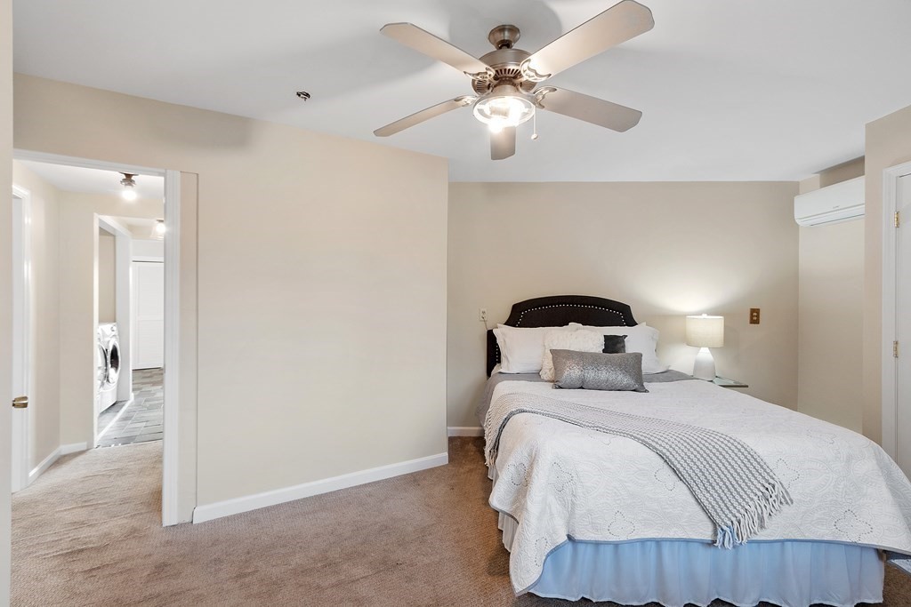 36 Osgood Road Sterling, MA 01564 - Photo 7 of 40 a bedroom with a bed and a chandelier