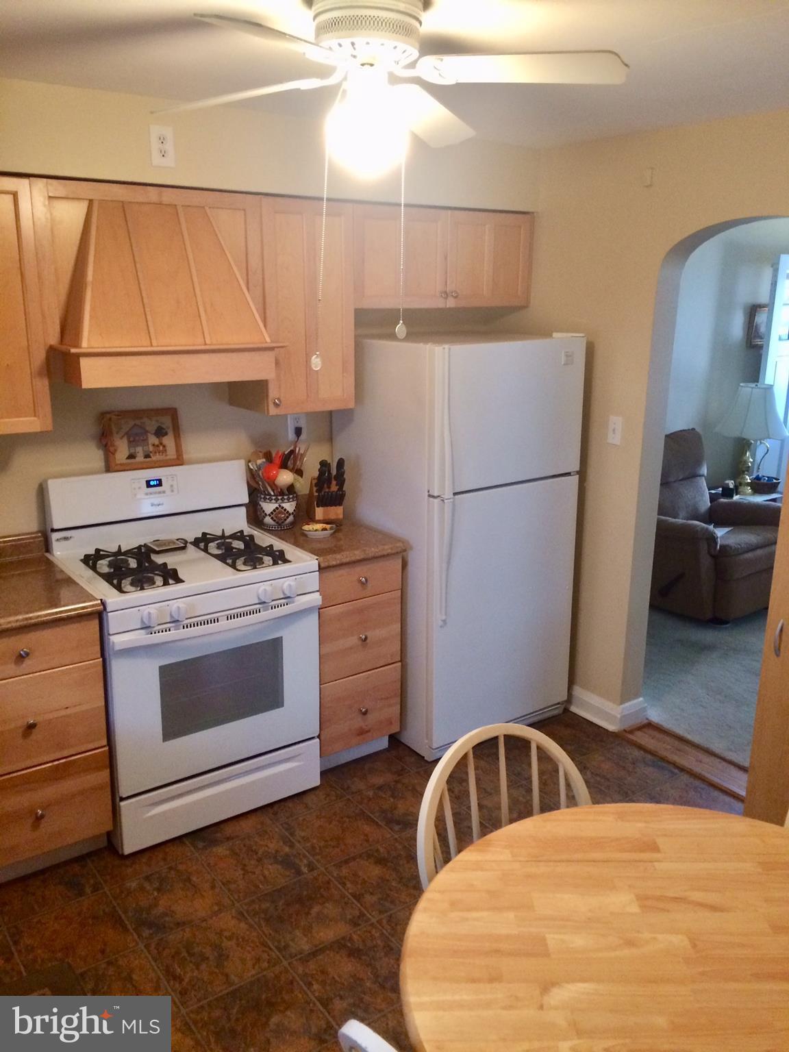 1248 June Road Baltimore, MD 21227 - Photo 6 of 18 a kitchen with a stove a sink and a refrigerator