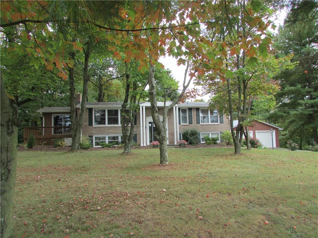 136 McKenzie Road Clinton, PA 15026 - Photo 1 of 25 Front of home. All brick home. Sunroom is cedar sided and detached garage. New metal roof on house and garage. Level yard with trees.
