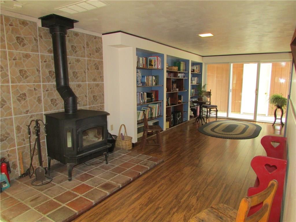 136 McKenzie Road Clinton, PA 15026 - Photo 20 of 25 Family room with woodburner in lower level.