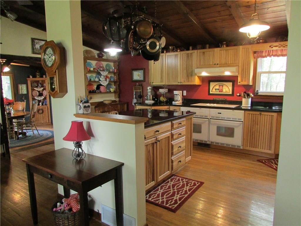 136 McKenzie Road Clinton, PA 15026 - Photo 7 of 25 Kitchen steps down to dining room with wood ceiling and hardwood floors.