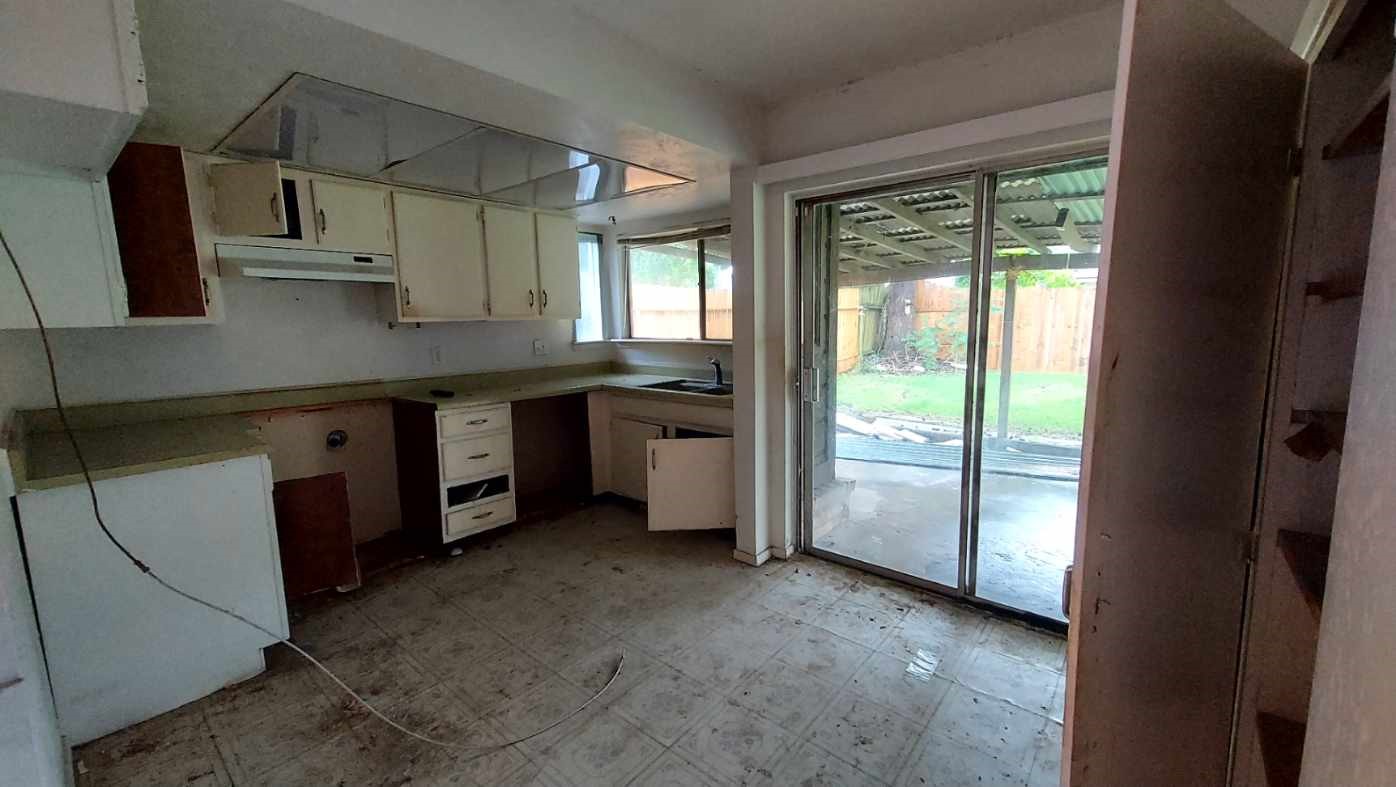 4411 Monteith Drive Spring, TX 77373 - Photo 2 of 15 a kitchen with a sink a counter top space and stainless steel appliances