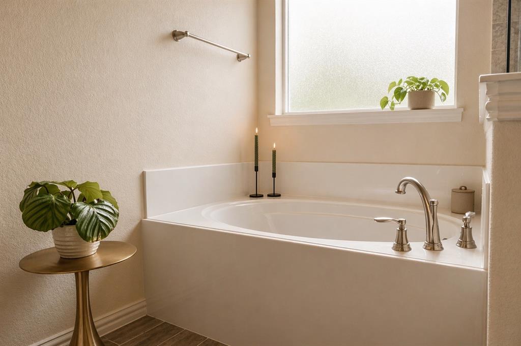 1530 County Road 200 Valley View, TX 76272 - Photo 22 of 34 Built-in soaking tub with brushed nickel fixtures and a frosted privacy window