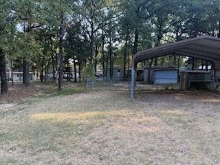 11257 Cedar Drive Mabank, TX 75156 - Photo 6 of 8 a view of backyard with large trees and wooden fence