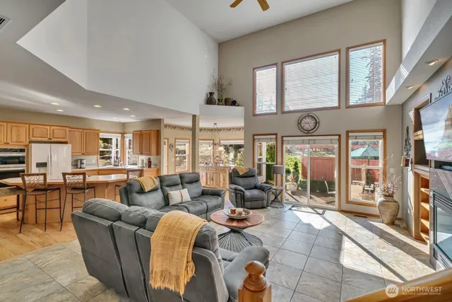 a living room with fireplace furniture and a large window