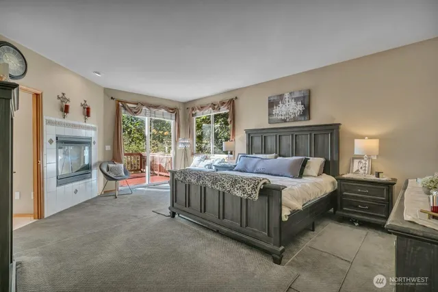 a spacious bedroom with a bed and a fireplace