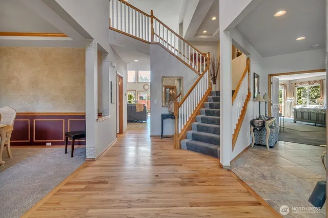 a view of entryway and hall with wooden floor