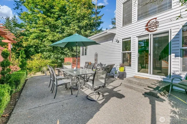 a view of a patio with table and chairs under an umbrella