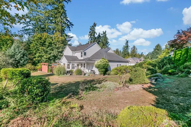 a view of a garden with a house