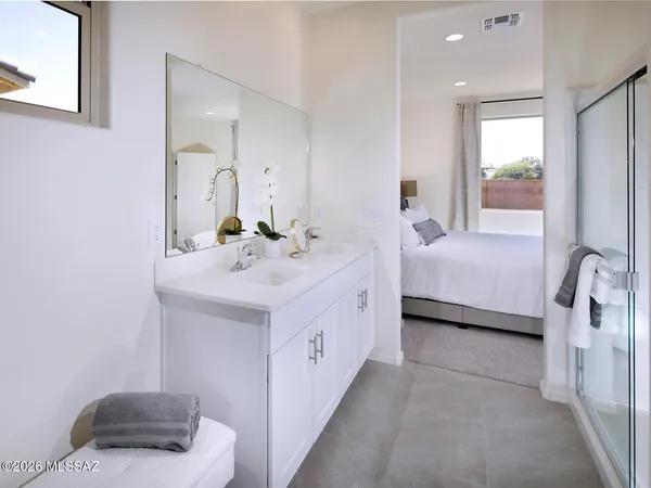 a bathroom with a double vanity sink and mirror