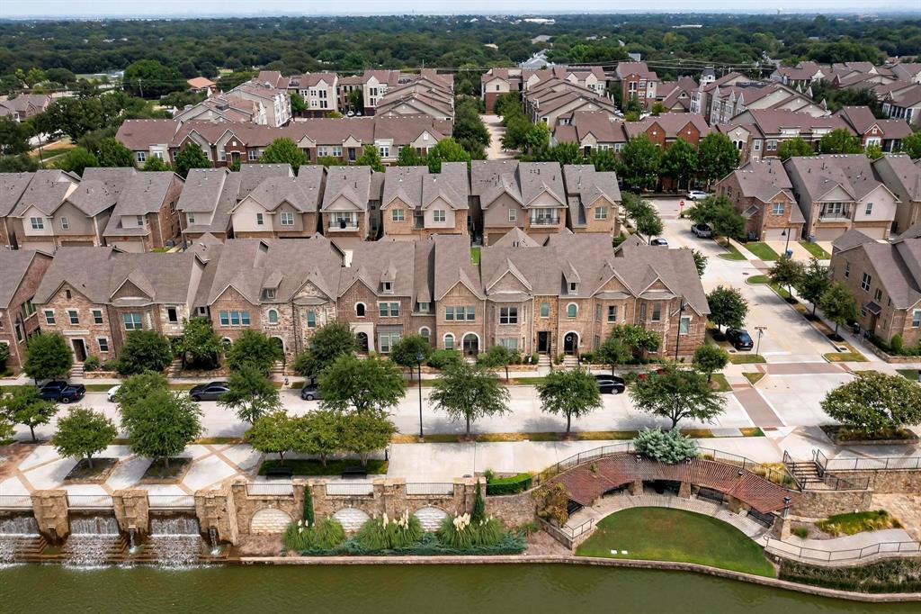 an aerial view of residential houses with outdoor space and swimming pool