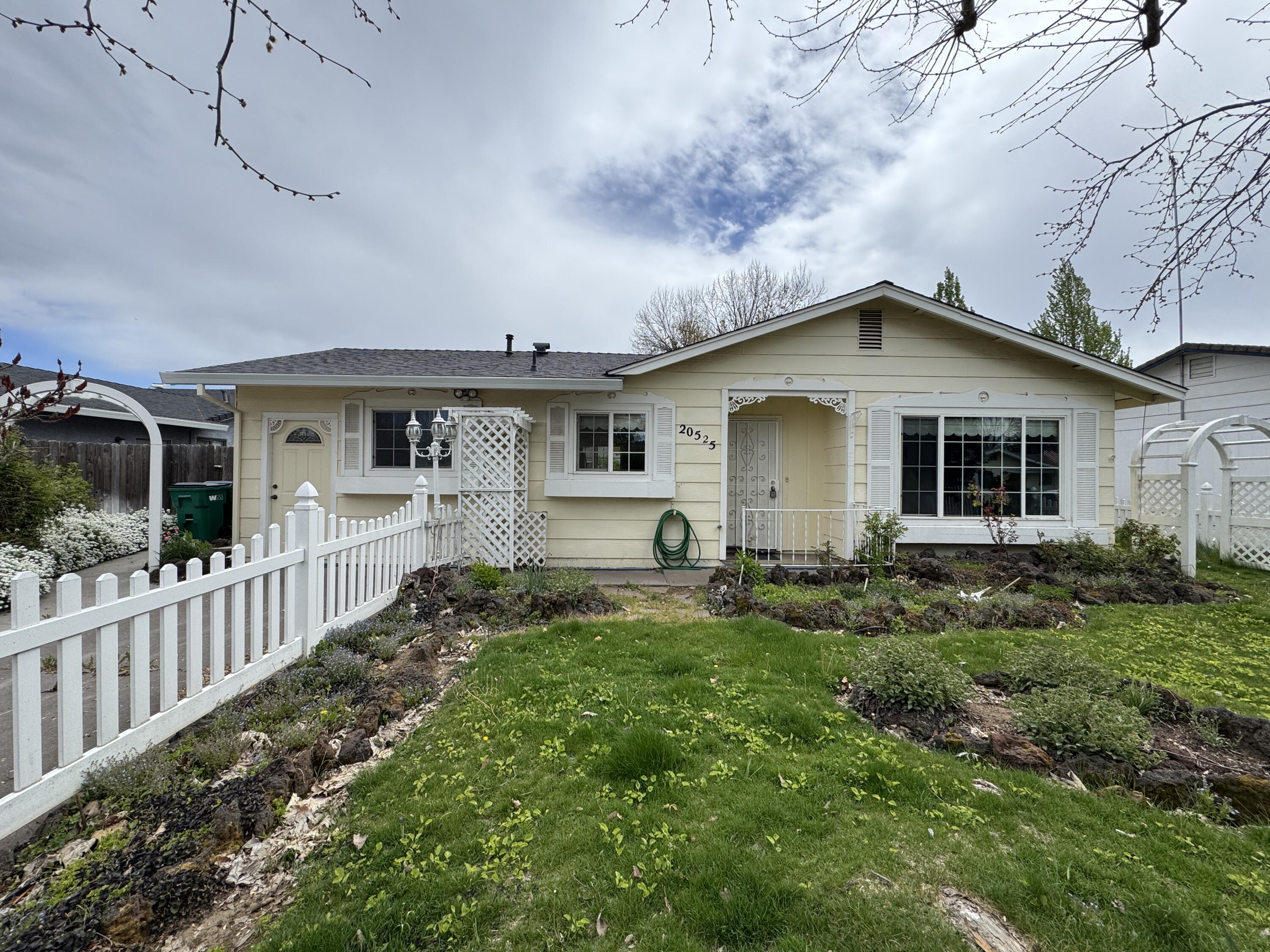 20525 Hudson Street Burney, CA 96013 - Photo 1 of 58 a front view of a house with a yard
