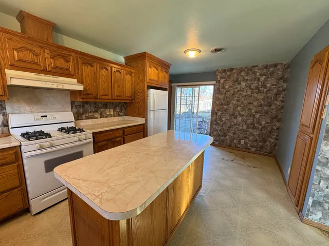 a bathroom with a sink toilet tub and shower