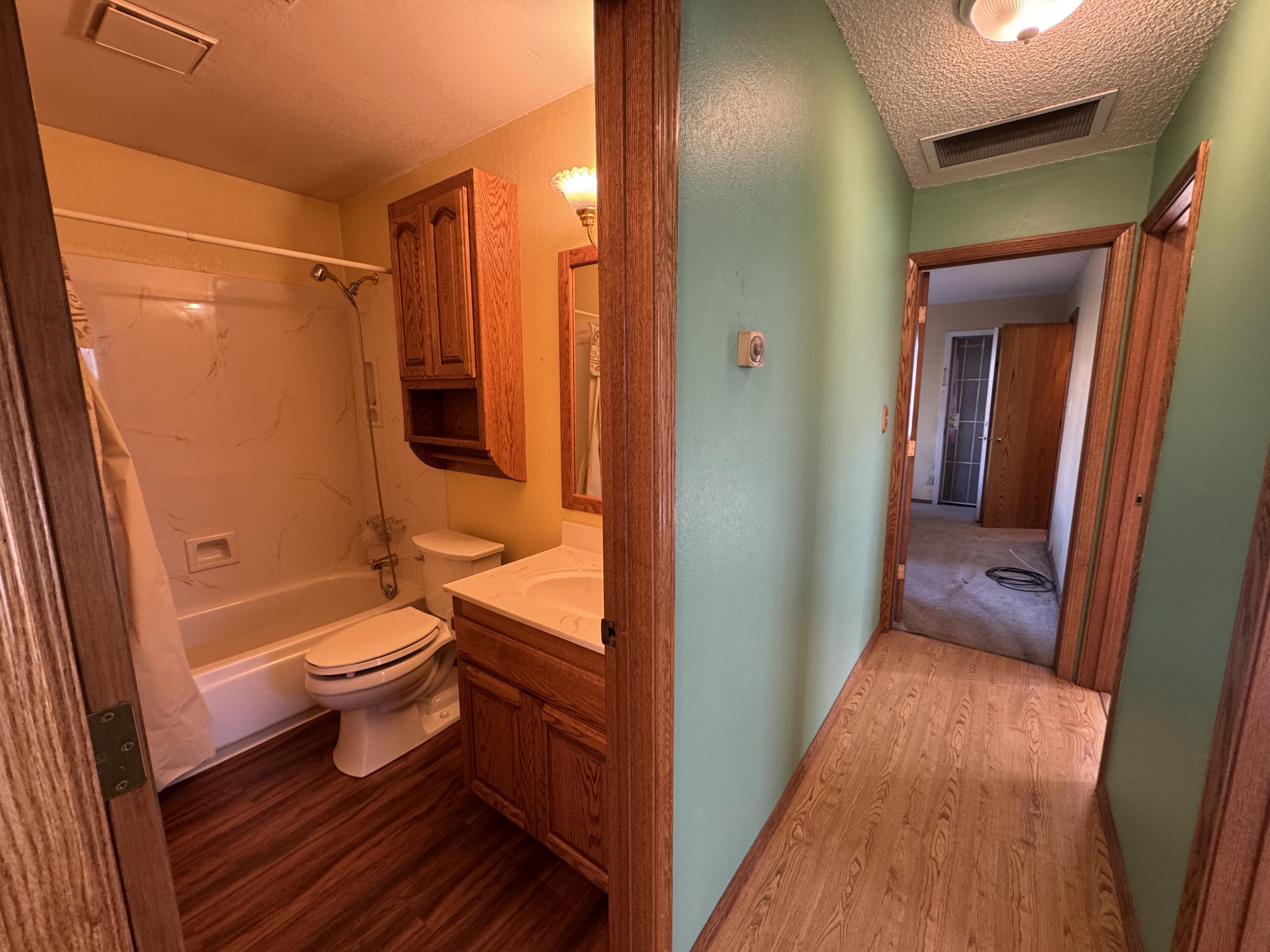 20525 Hudson Street Burney, CA 96013 - Photo 29 of 58 a bathroom with a granite countertop toilet a sink and shower