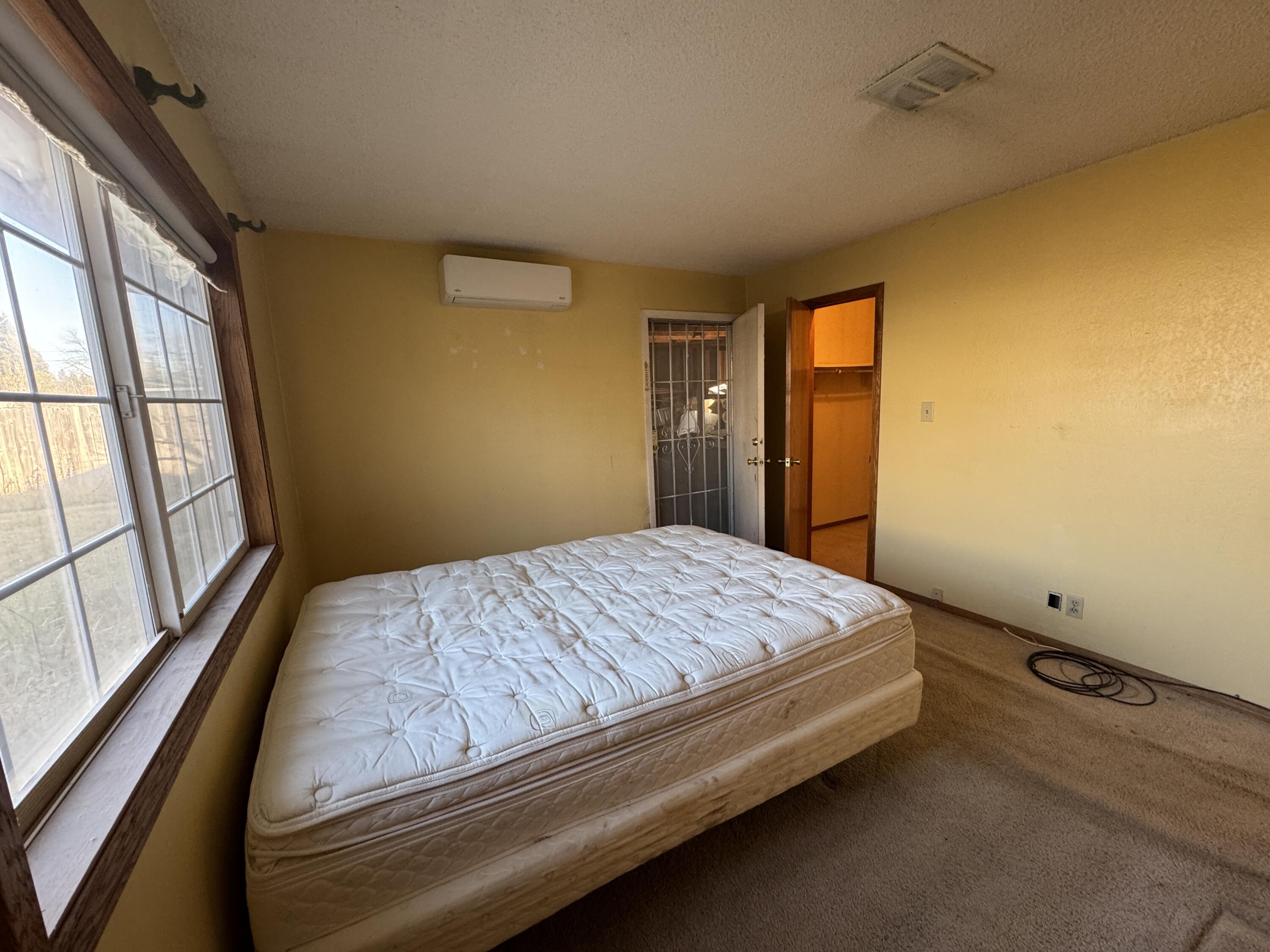 20525 Hudson Street Burney, CA 96013 - Photo 39 of 58 a bedroom with a bed and wooden floor