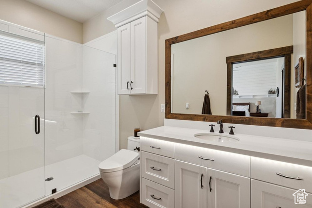 6117 North Rocky Ridge Road Peoa, UT 84061 - Photo 52 of 83 Bathroom with a shower with door, vanity, hardwood / wood-style floors, and toilet