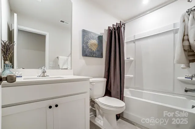 a view of a hallway with paintings on the wall