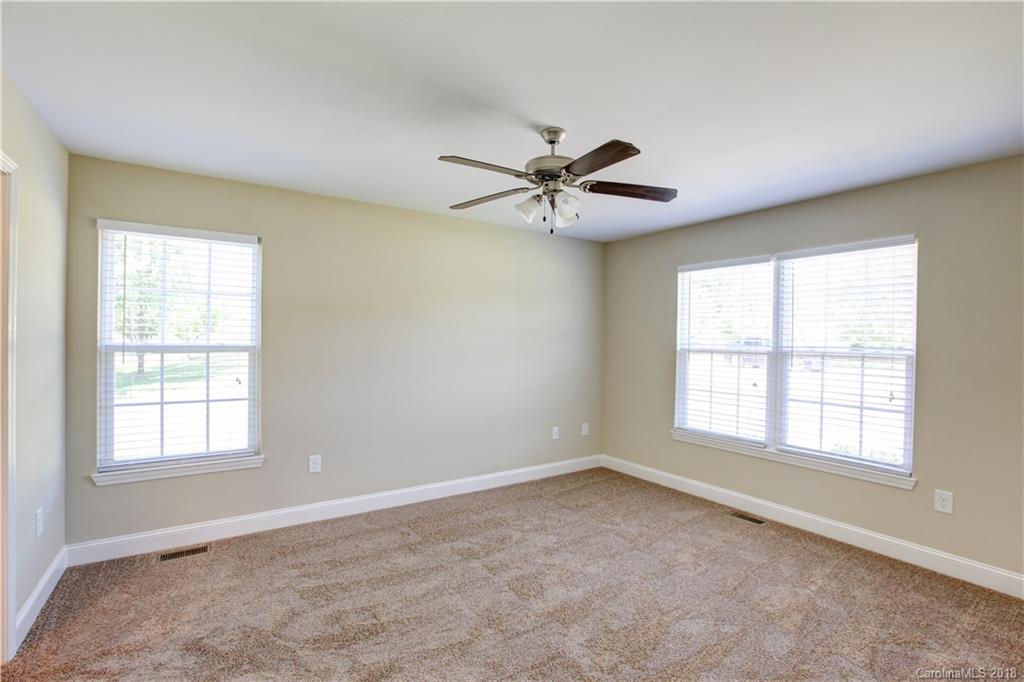 3713 Austin Road Monroe, NC 28112 - Photo 14 of 19 an empty room with chandelier fan and windows