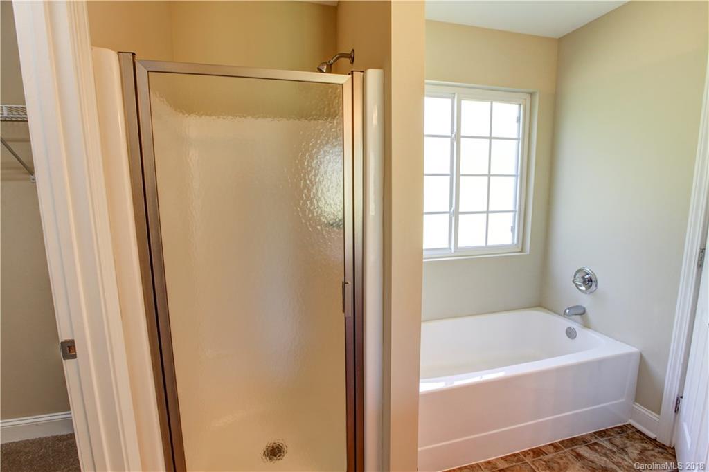 3713 Austin Road Monroe, NC 28112 - Photo 16 of 19 a bathroom with a bathtub and a shower