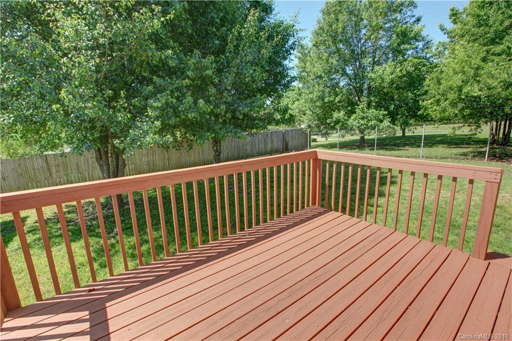 3713 Austin Road Monroe, NC 28112 - Photo 6 of 19 a balcony with wooden floor and trees in the back