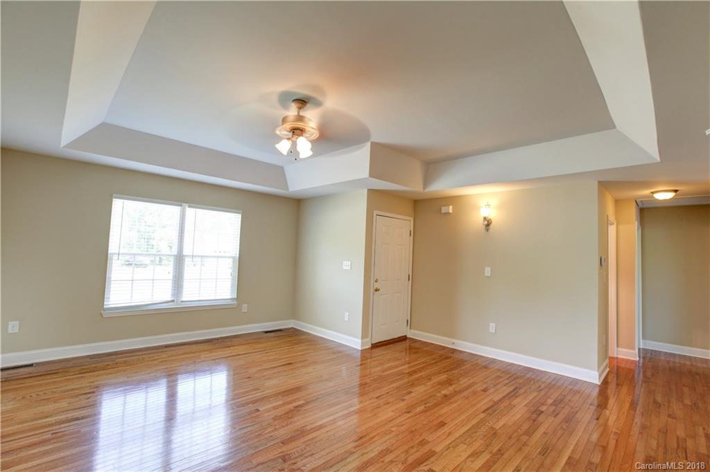 3713 Austin Road Monroe, NC 28112 - Photo 8 of 19 an empty room with wooden floor and windows