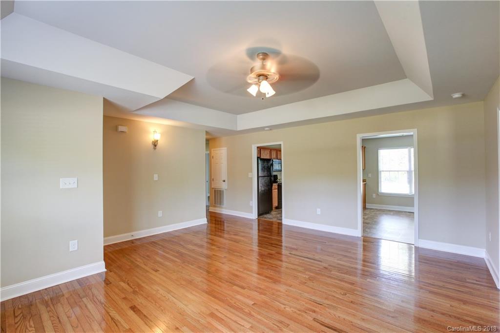 3713 Austin Road Monroe, NC 28112 - Photo 9 of 19 wooden floor in an empty room with a window