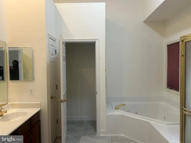 a bath room with a bath tub and a sink