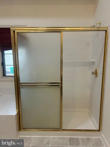 a bathroom with a glass shower door