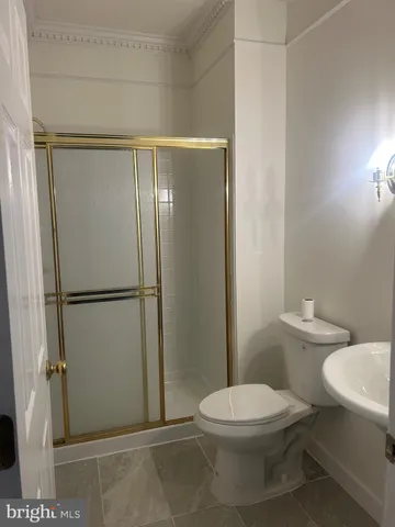 a bathroom with a toilet and a shower