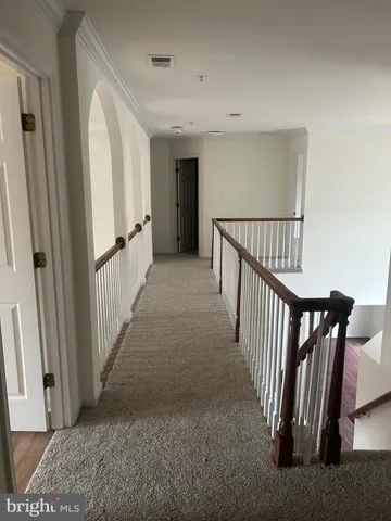 a view of a hallway with staircase