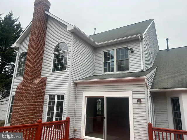a view of a house with a small deck