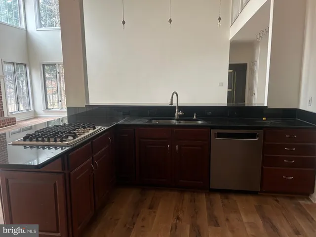 a kitchen with granite countertop a sink and a stove