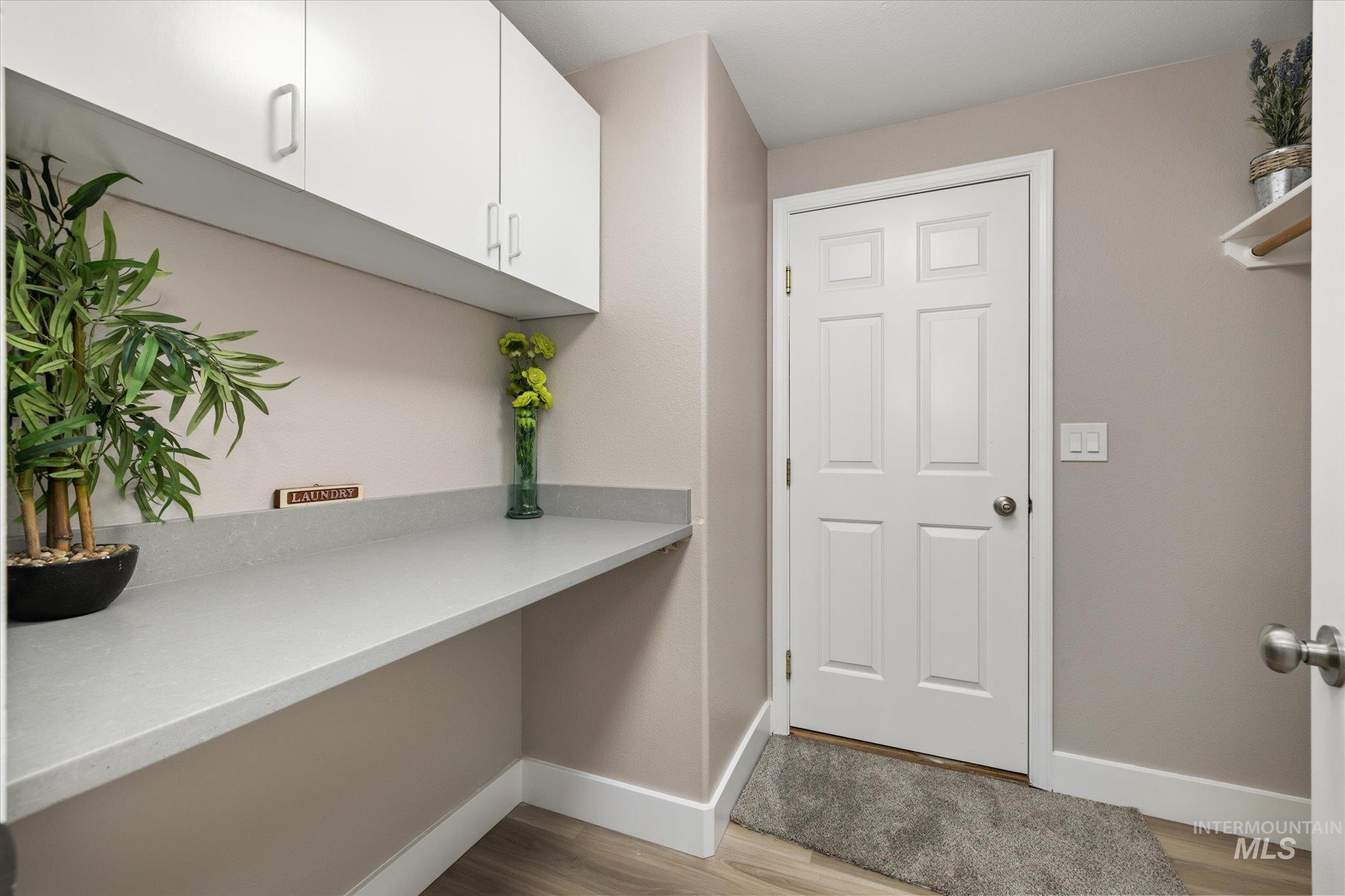 2250 North Amethyst Avenue Meridian, ID 83646 - Photo 42 of 50 Laundry room featuring light wood-style floors and baseboards