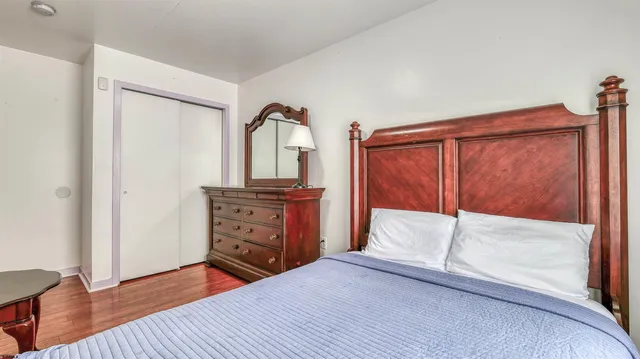 a bedroom with a bed and a dresser