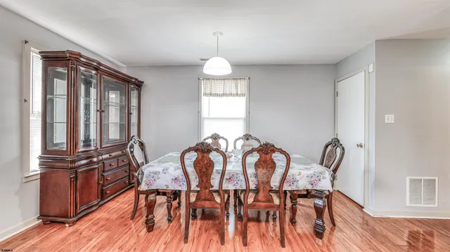 a view of a dining room with furniture and chandelier