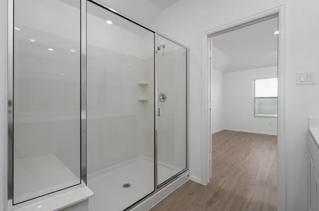a bathroom with a glass shower door