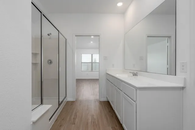 a bathroom with a double vanity sink and mirror