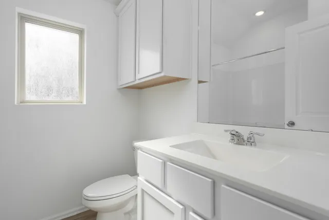 a bathroom with a sink toilet and vanity