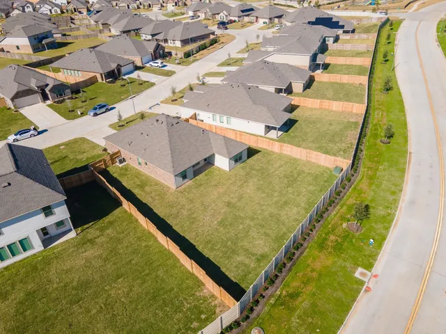 an aerial view of residential houses with outdoor space